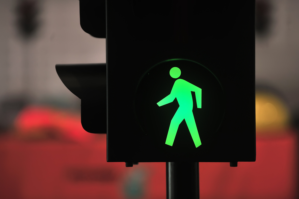 Pedestrian crossing signal with green man light on