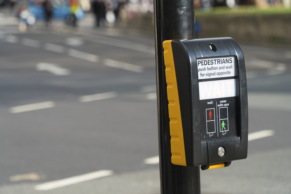 Photograph of a pedestrian button crossing next to road