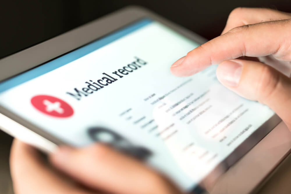 Woman checking her medical record on her tablet after a data breach