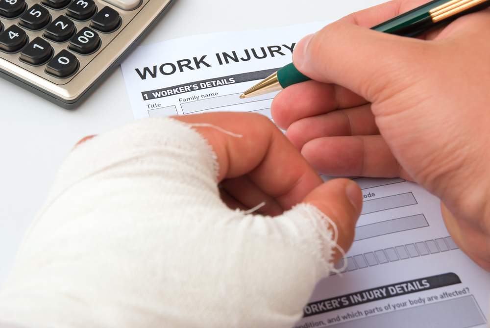 Man with broken hand filling in a work injury claim