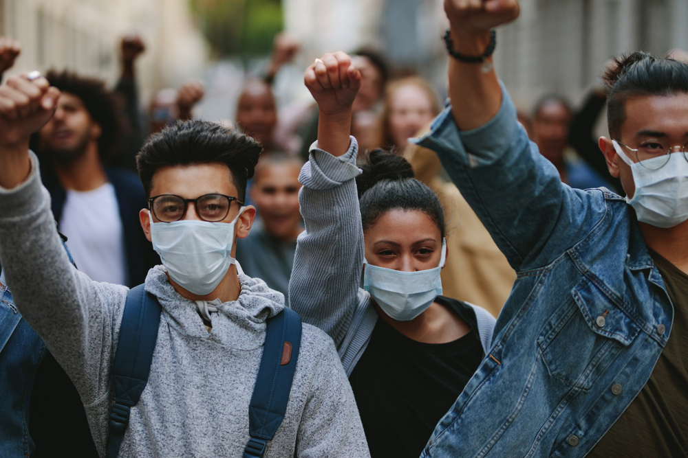 Group of people at Black Lives Matter protest wearing COVID protection face masks 