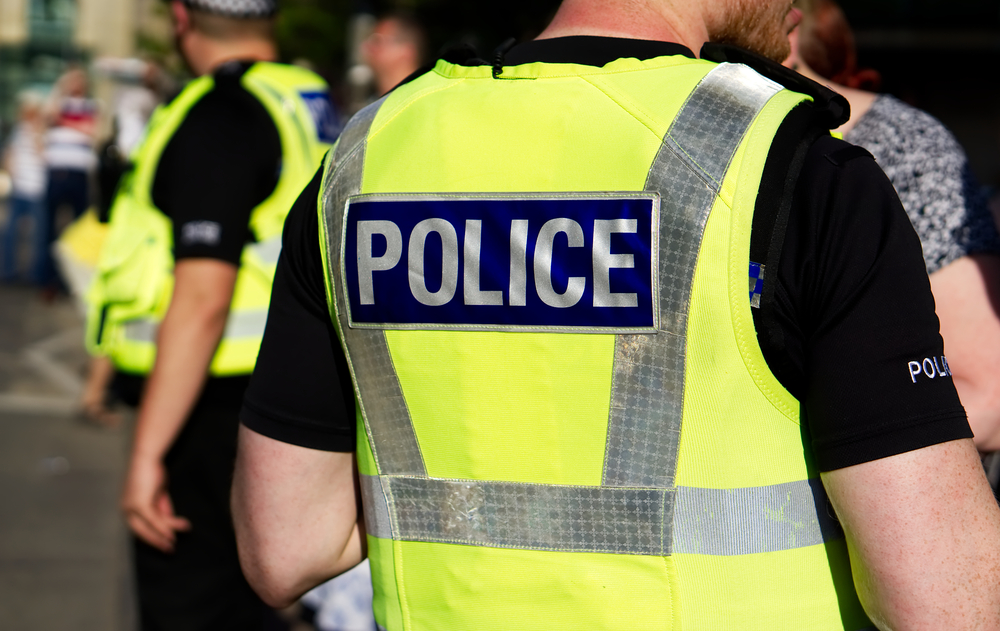 Close-up photograph of police man's high vis jacket whilst he attends a crowd event