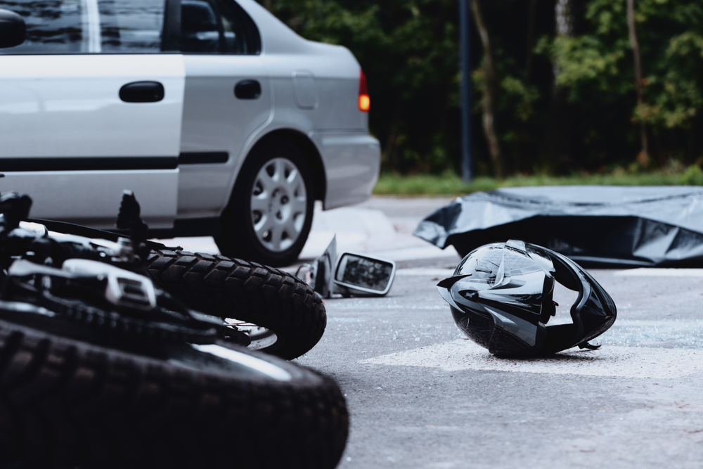 Road traffic incident involving a white car and a motorcycle