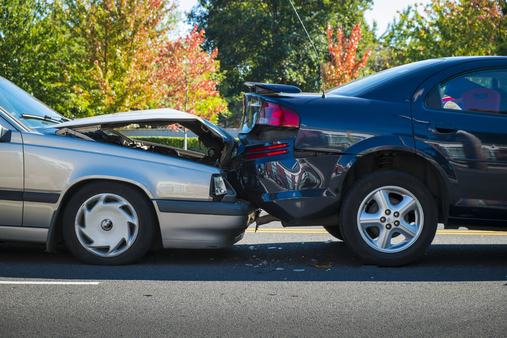 Photograph of a grey and black car involved in a collision incident 