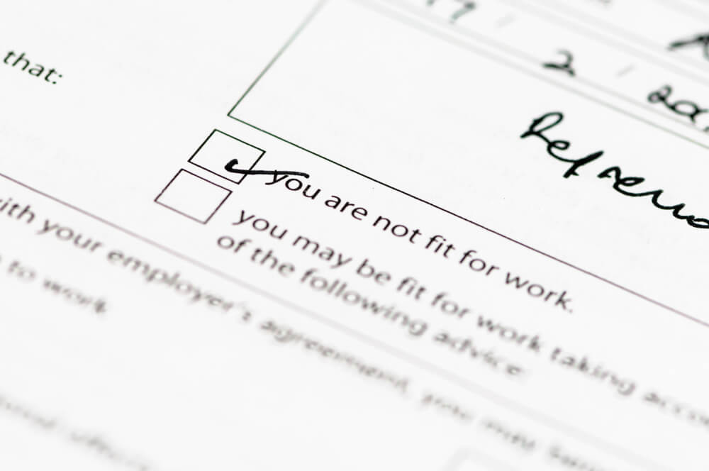 Close-up of a doctor's note for Statutory Sick Pay with the "you are not fit for work" checkbox ticked 