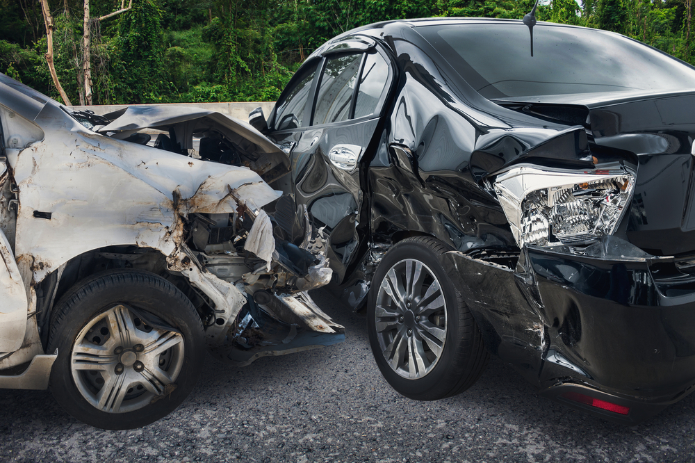 Image of black and silver cars after a front collision 