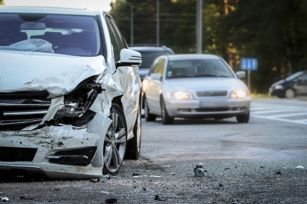 Photograph of hit and run incident between two white cars