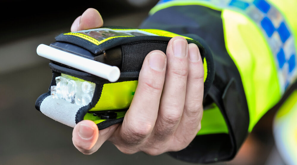 Policeman holding a breathalyser