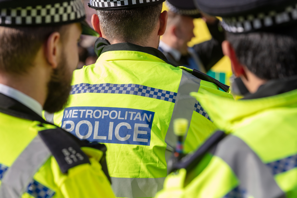 Rear view of Metropolitan Police Officers Wearing High Visibility Jackets in London