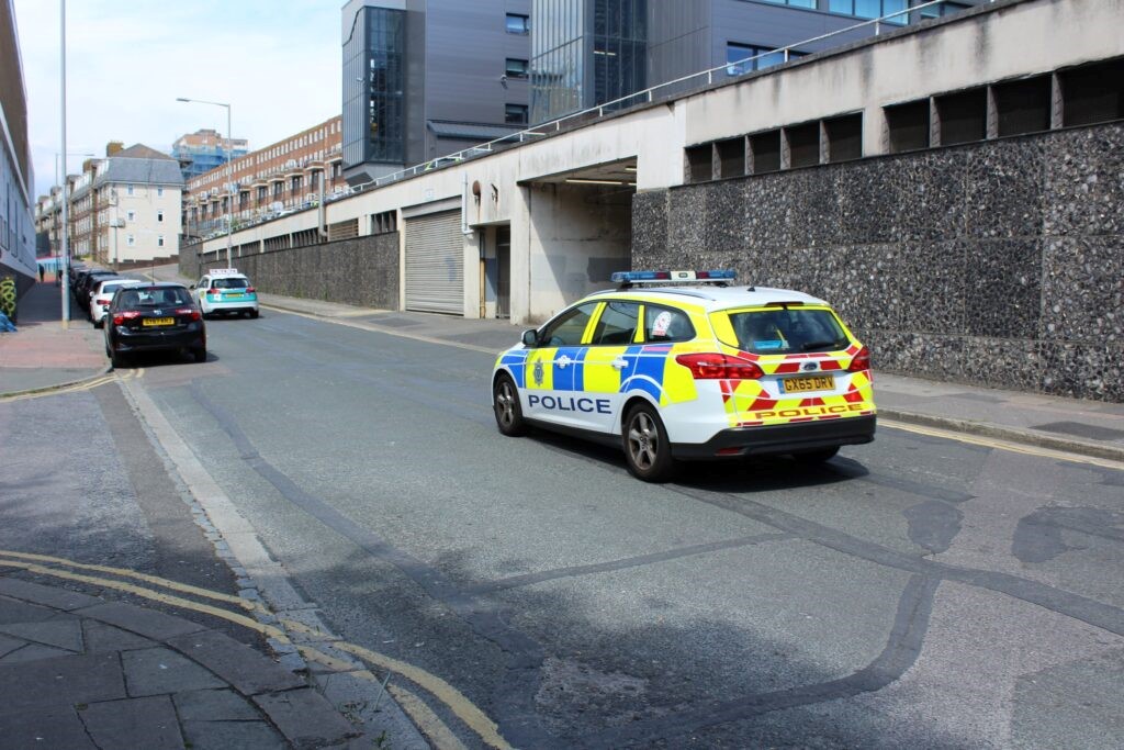 A police car driving down the road. 