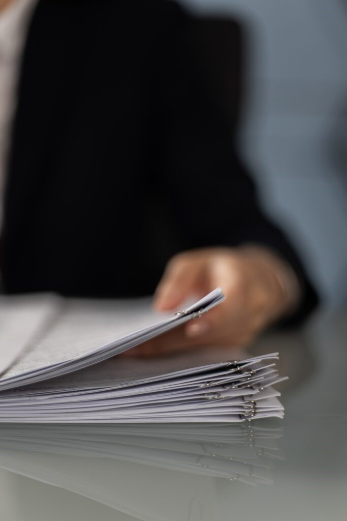 A person holding a folder working through a victim support case.