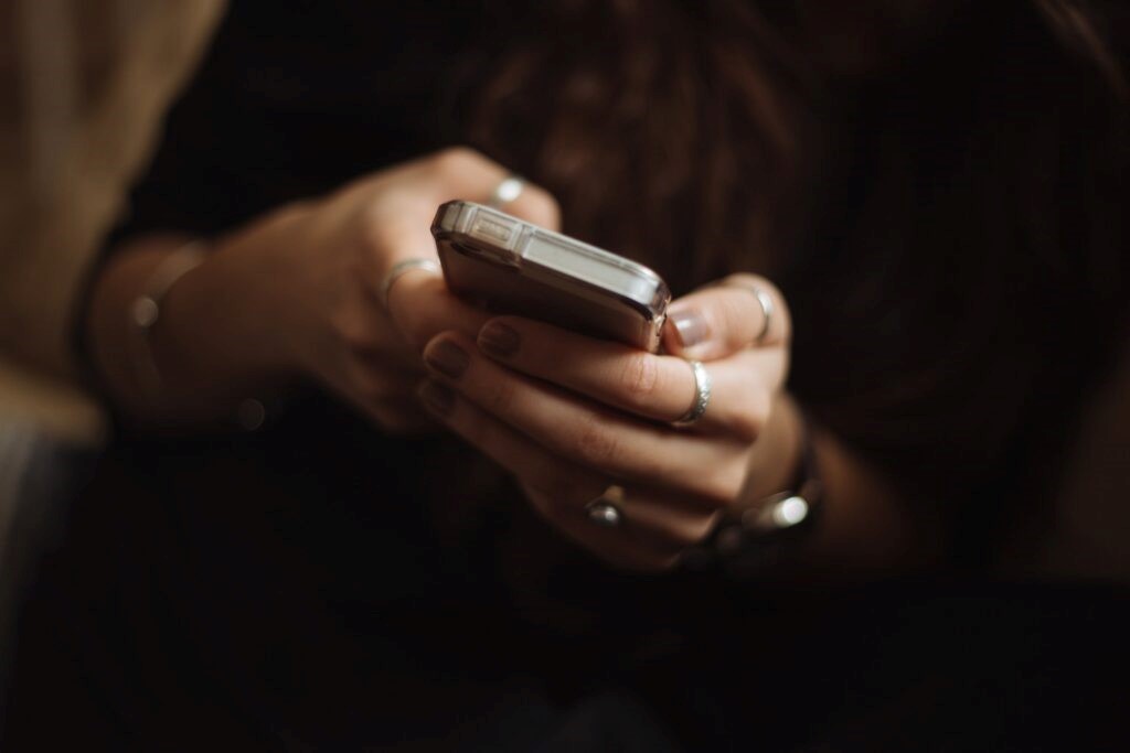 A person on their phone researching what is victim support. 