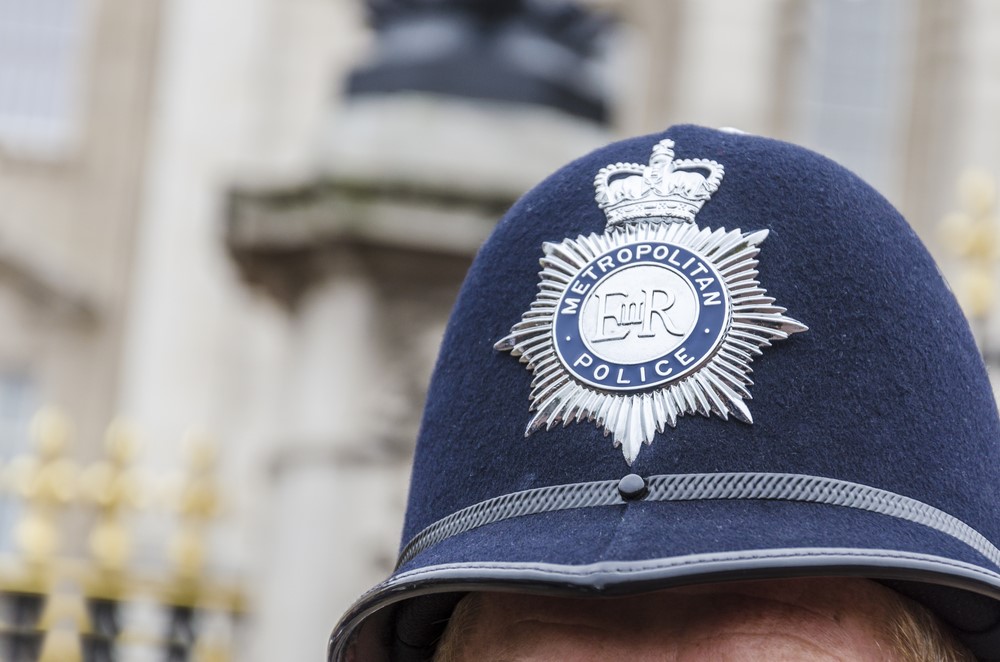 Image of a police officers hat with a silver Metropolitan Police badge on the front.