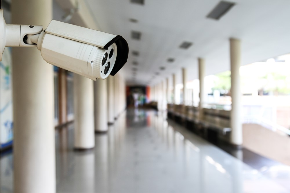 Image of a CCTV camera in a school corridor.