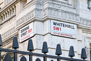 A street sign for Downing Street and Whitehall in the City of Westminster, the home of the UK Government. 