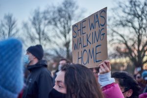 A sign reads "she was walking home" at a Sarah Everard vigil in Clapham Common, taken March 2021.