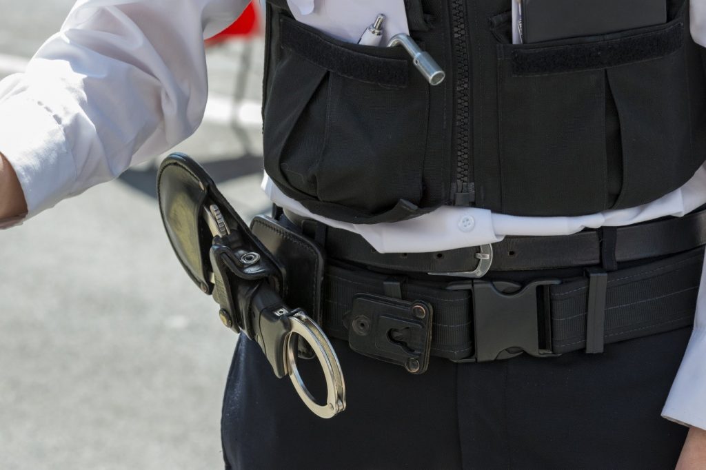 Image of a police officers belt with handcuffs 