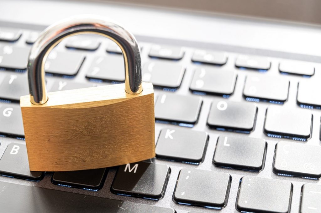 data breach concept image, a picture of a padlock on a keyboard 