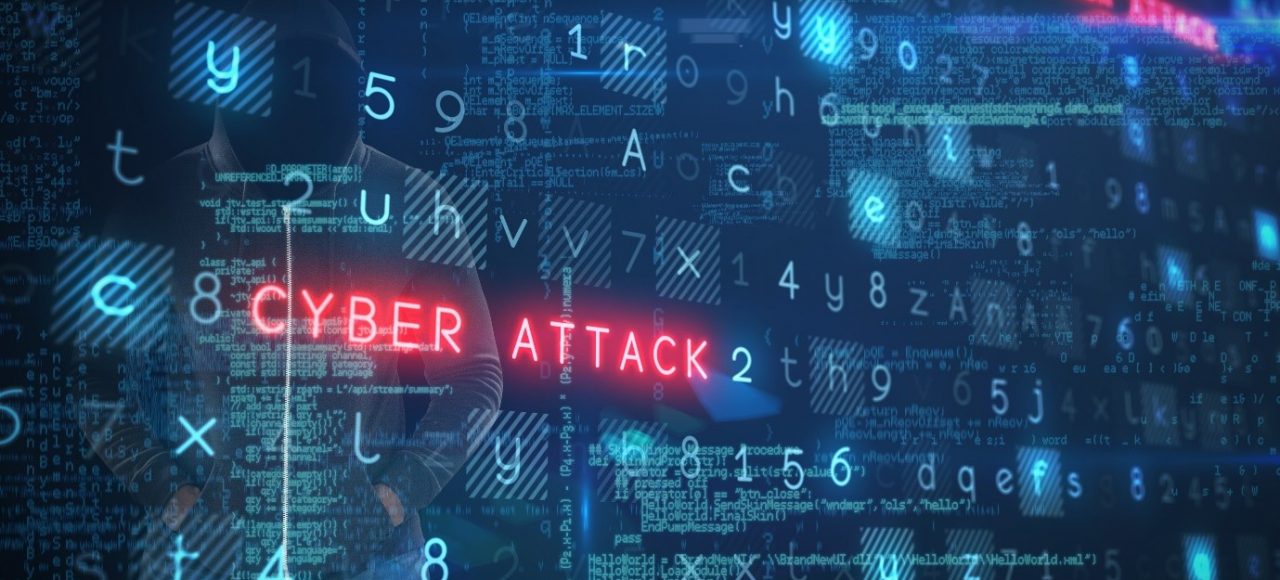 Image of a blue screen full on numbers and letters with the words 'CYBER ATTACK' written in neon red, behind the screen is a hooded man