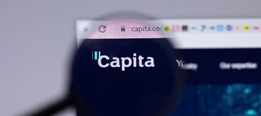 Capita data breach concept image. Image of the Capita website with a magnifying glass in front of it magnifying the Capita symbol.