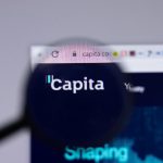 Capita data breach concept image. Image of the Capita website with a magnifying glass in front of it magnifying the Capita symbol.