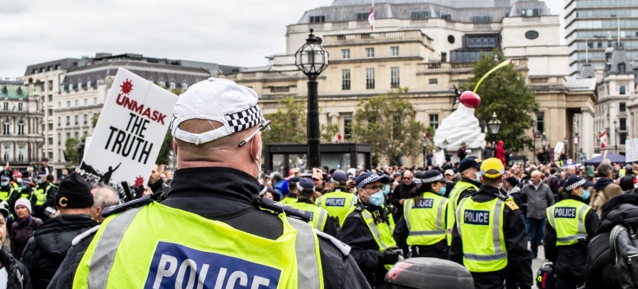 Picture of a COVID protest being policed in the UK