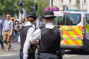 Police Women in front of police van