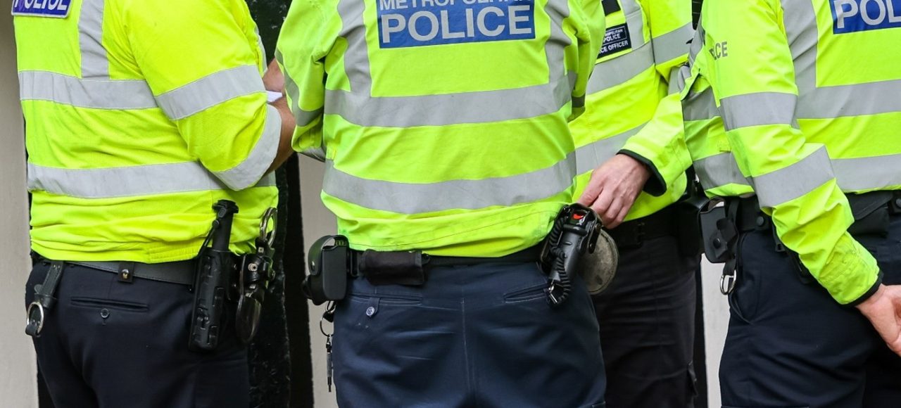 Photograph of four Metropolitan Police Officers wearing high-vis jackets.