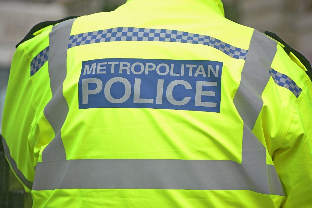 Image of the back of a Metropolitan Police officers high-visibility jacket. 