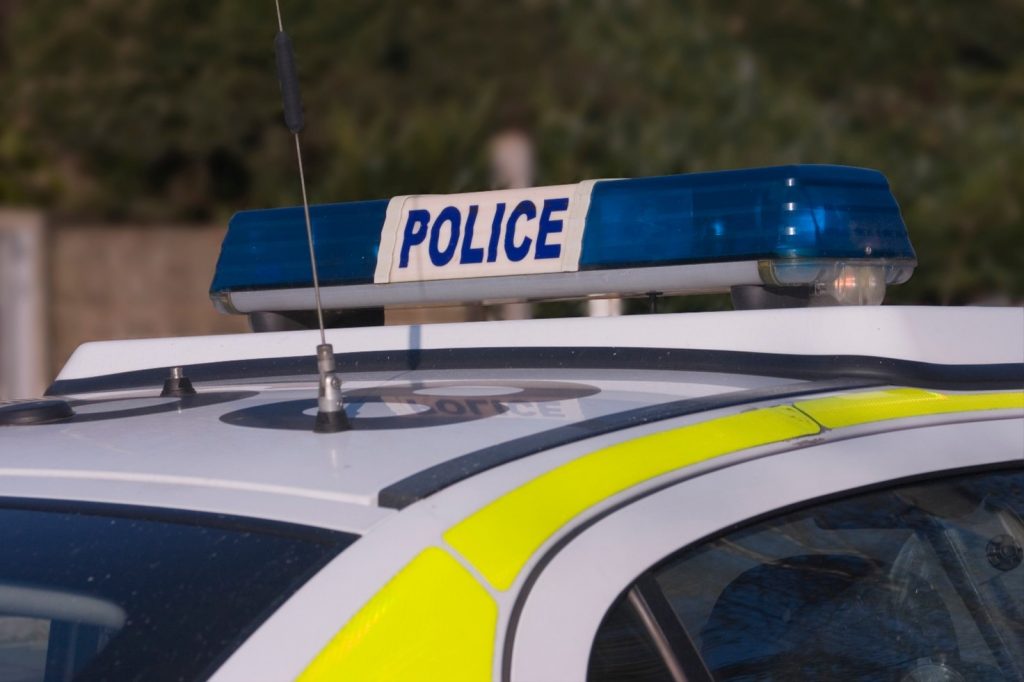 Up close image of a police siren on top of a UK police car.