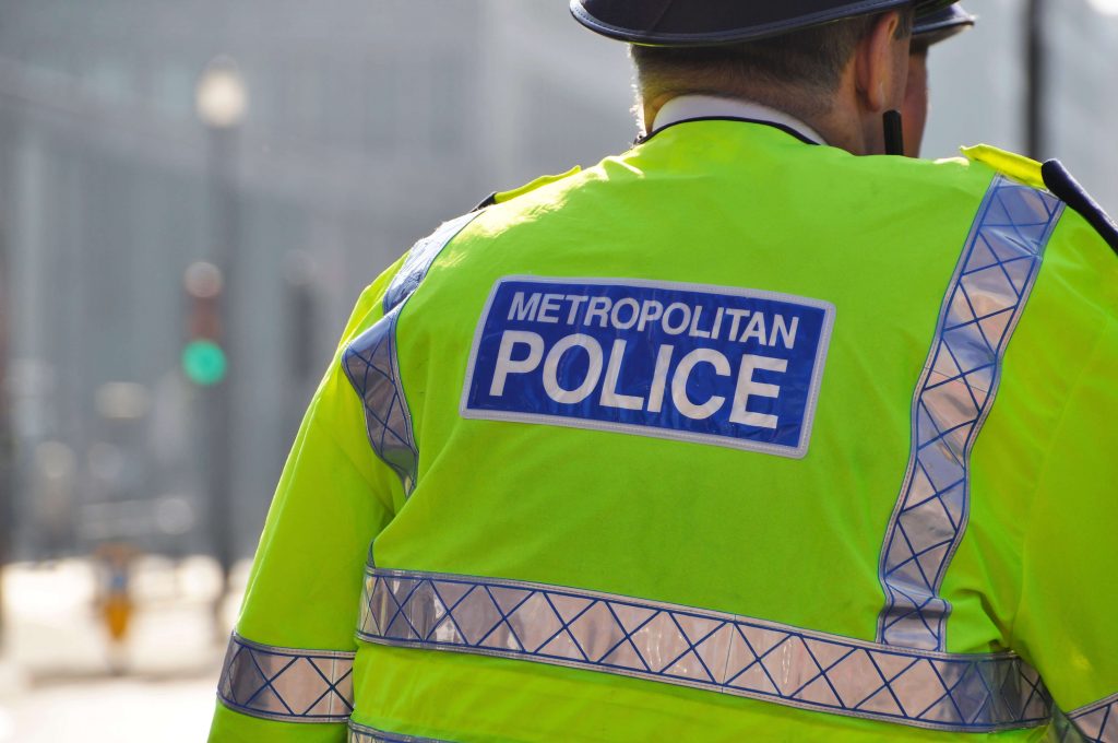Picture of the back of a Metropolitan Police officer wearing a high visibility jacket
