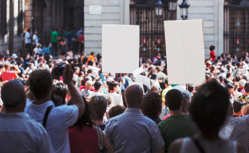 Protesting demonstration holding signs in city 