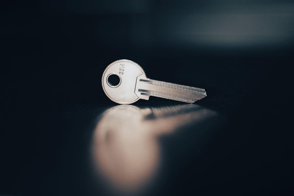 Picture of a key resting on a flat black surface