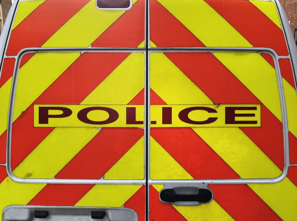 Red and yellow stripes on the back of a police van