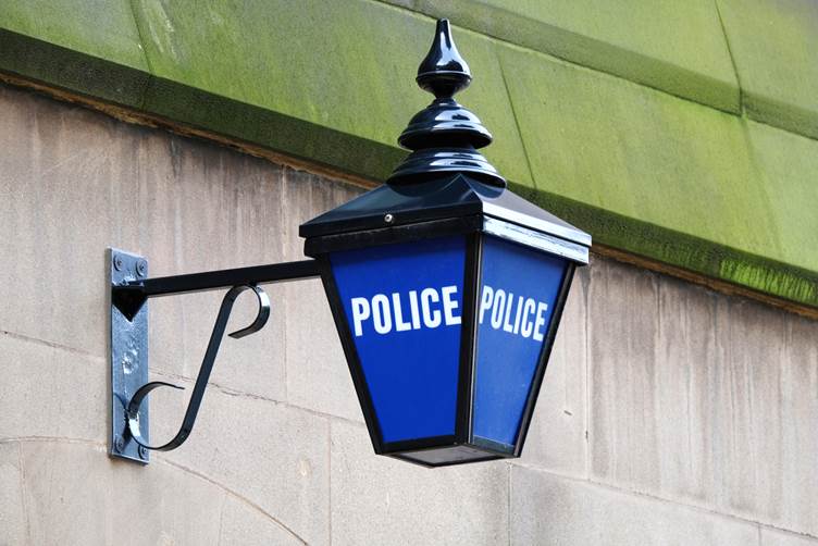 Picture of a blue police light outside a police station