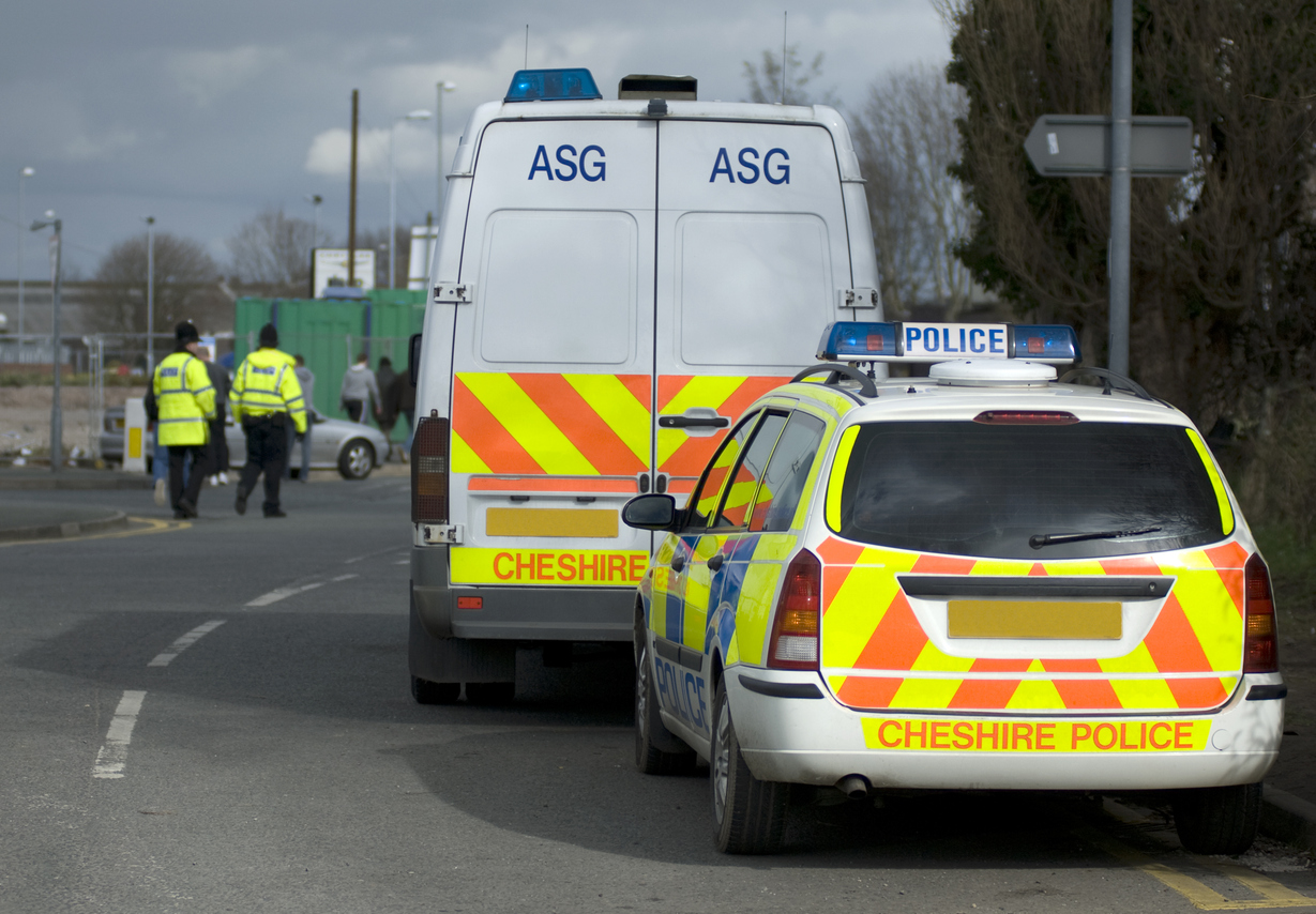 Uk police vehicles at the scene of a public disturbance