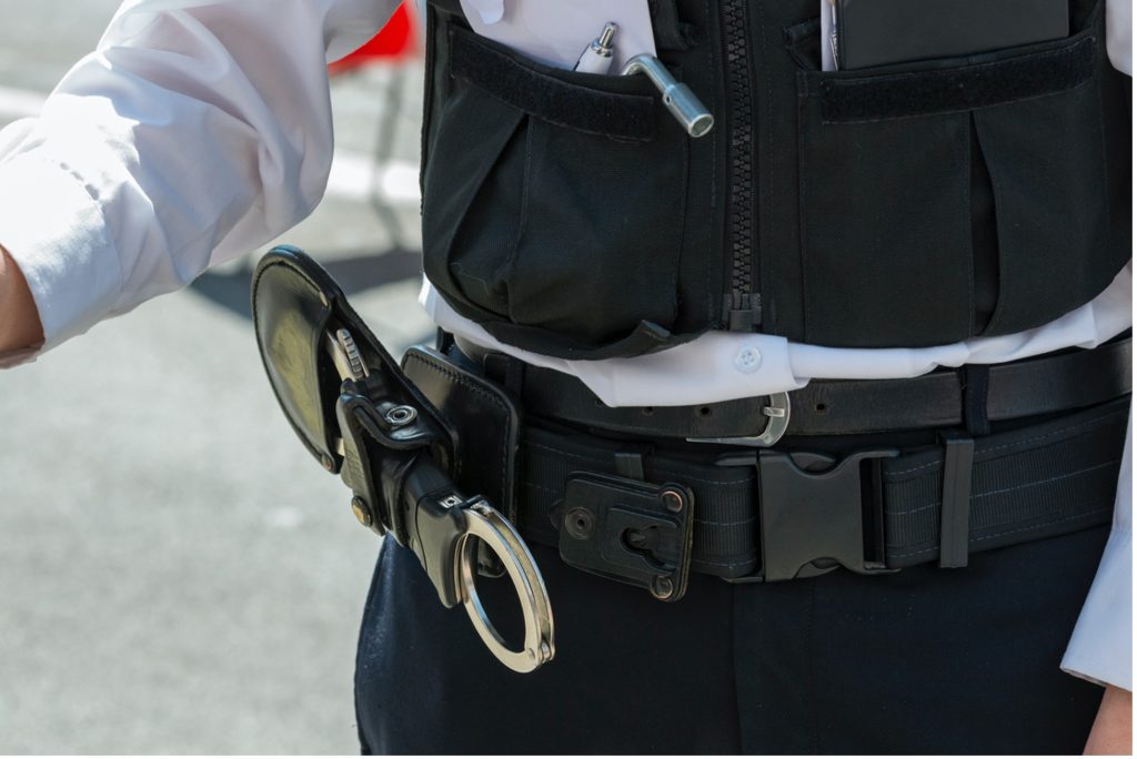 A picture of a police officers belt with handcuffs attached 