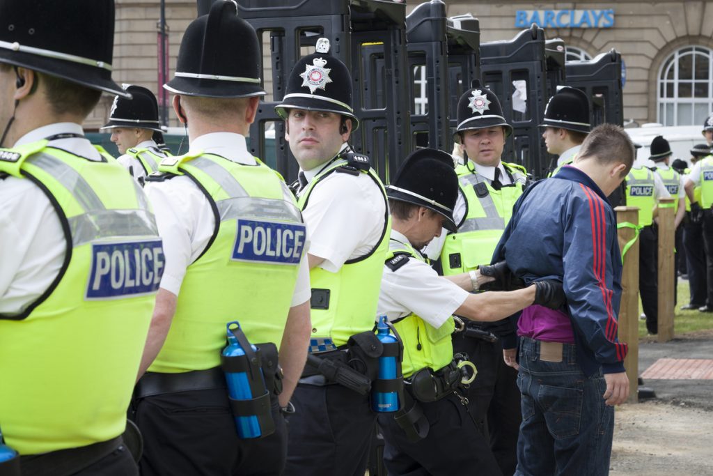  A young man is searched by the police before he can enter a rally held by the English Defence League. The police conducted body searches and used knife-arches to check for weapons before allowing people into the area set aside for the rally. The EDL are a far right group who held a rally in the city of Bradford, which has a large muslim population. Although the EDL said that thousands would join them, only around 800 showed up, according to police estimates.