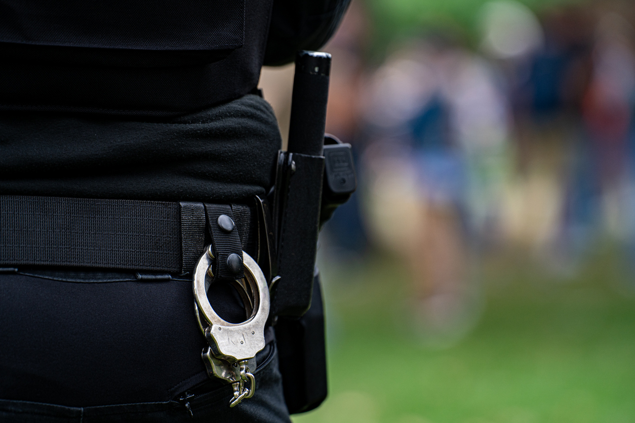 Close up of police handcuffs on duty belt.
